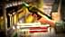 Individual holding a green bottle of olive oil while shopping in a grocery store aisle. - Olive Oil Times