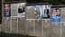 Various political campaign posters displayed on a concrete wall with numbered sections. - Olive Oil Times