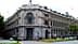 A large historic building in Madrid featuring ornate architectural details and a clock on the facade. - Olive Oil Times