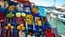 Assorted fresh fruits and vegetables displayed in blue crates at a market by the water. - Olive Oil Times