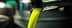 Golden green olive oil pouring from a metal spout in a production facility. - Olive Oil Times