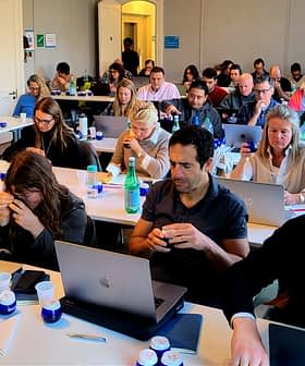 Participants seated at tables with laptops during a workshop session, focused on their tasks. - Olive Oil Times