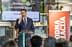 A man in a suit speaking at a podium during an event about olive oil as a tourist brand. - Olive Oil Times