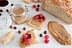 Slices of bread spread with nut butter and topped with raspberries, alongside a jar of nut butter. - Olive Oil Times